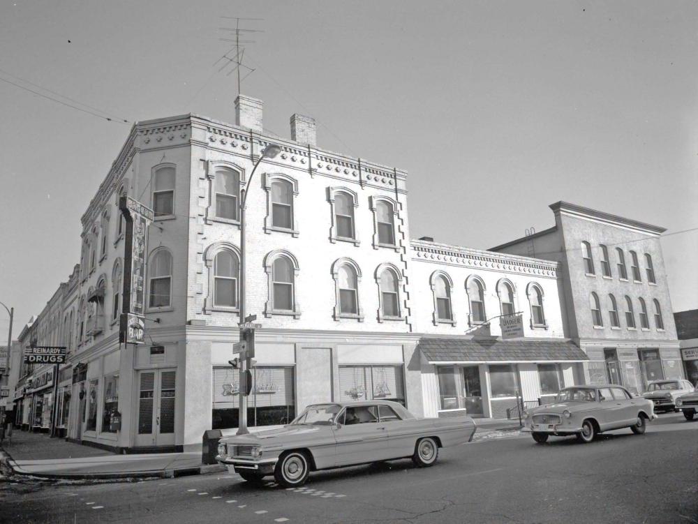 Downtown buildings and old cars